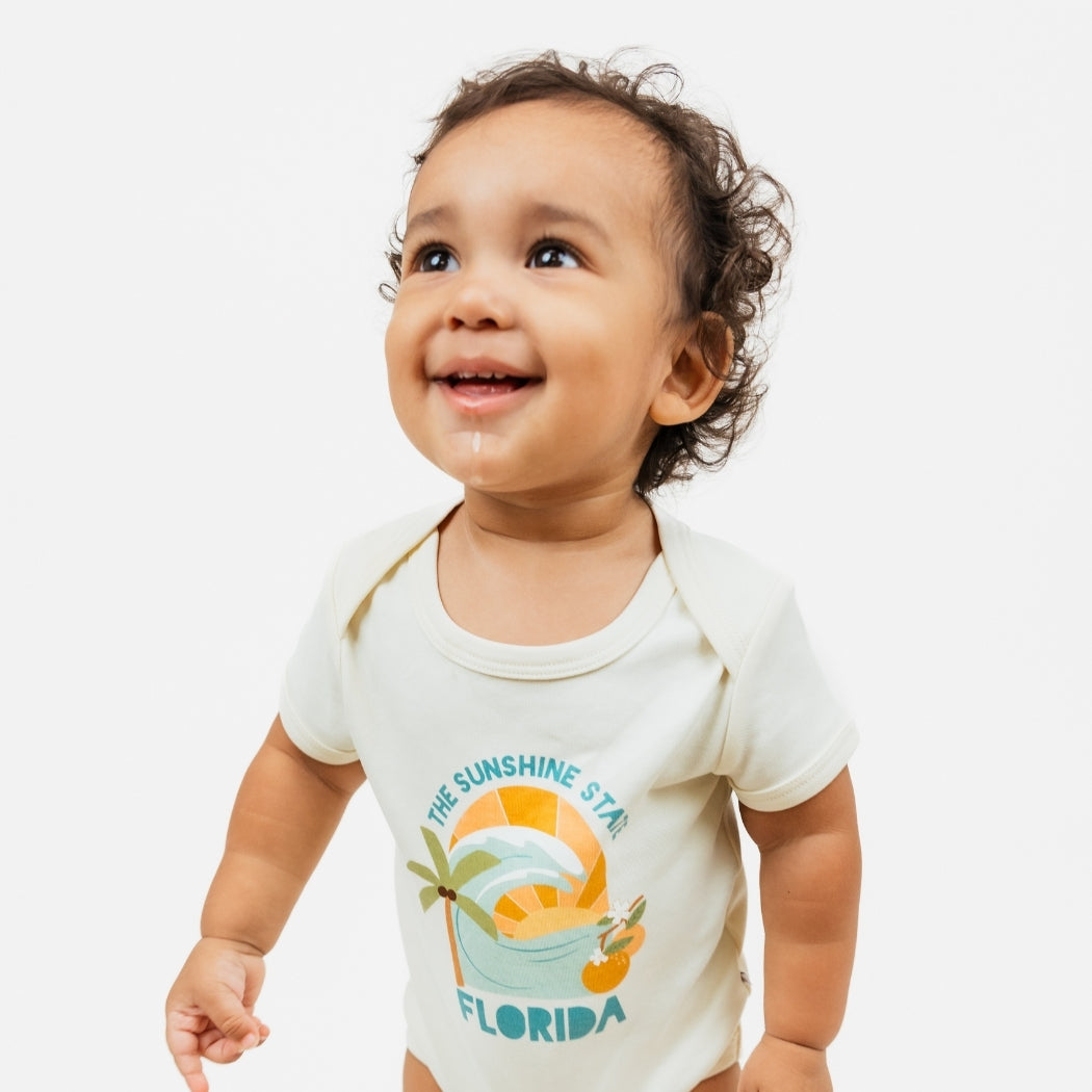 Florida Sunshine State baby bodysuit – soft & stretchy 100% cotton with unique vintage-inspired print, snap bottom, and fold-over shoulders for easy dressing.