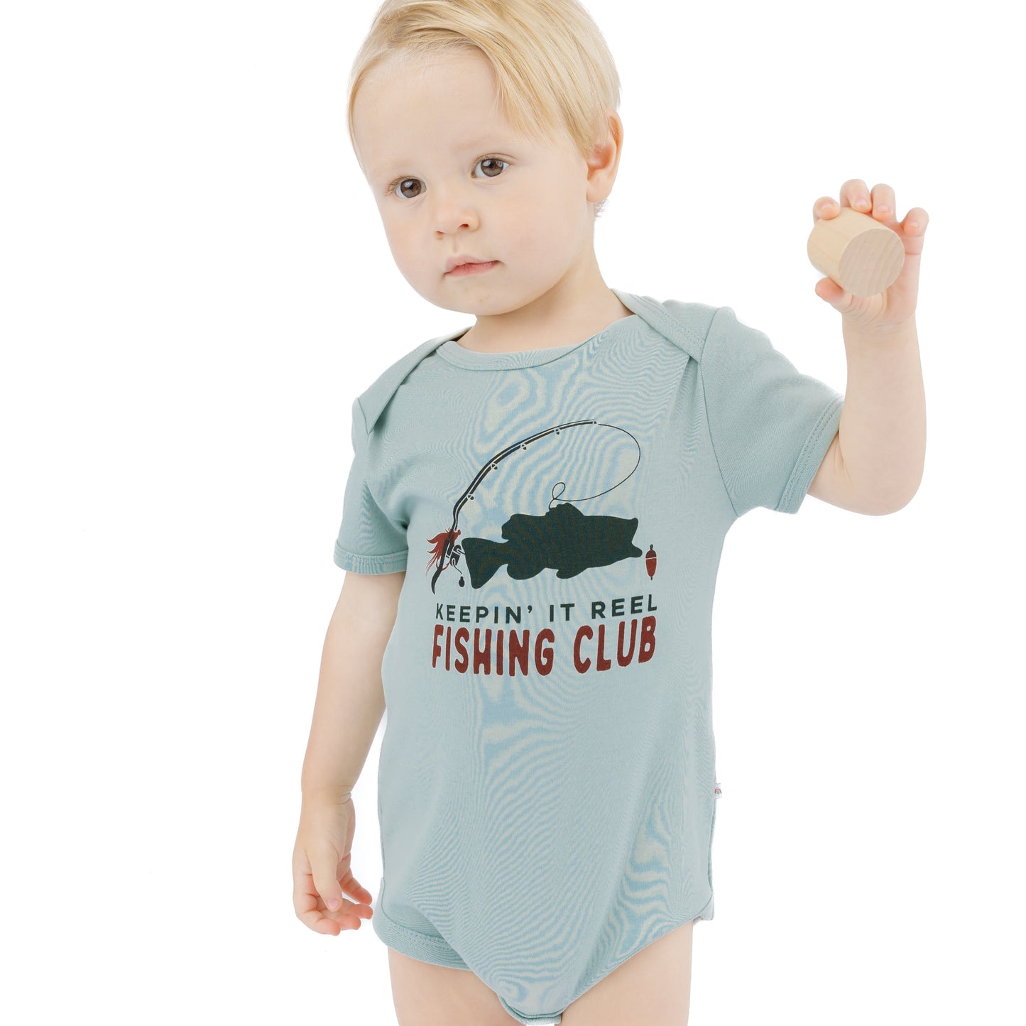 little boy in blue bodysuit with fish print