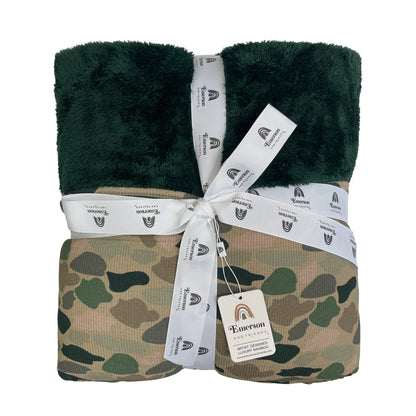 bamboo blanket with camo print and green fleece lining on white background.