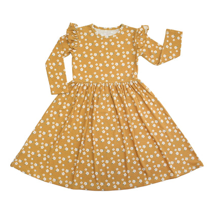 Yellow dress with white floral pattern on a white background