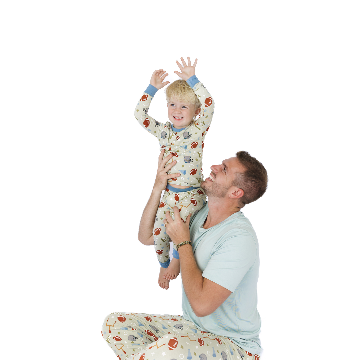 Man and child in matching pajamas on a white background