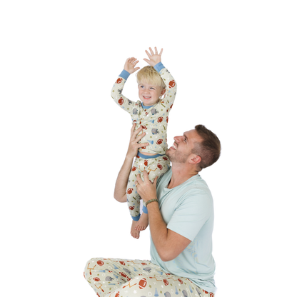 Man and child in matching pajamas on a white background