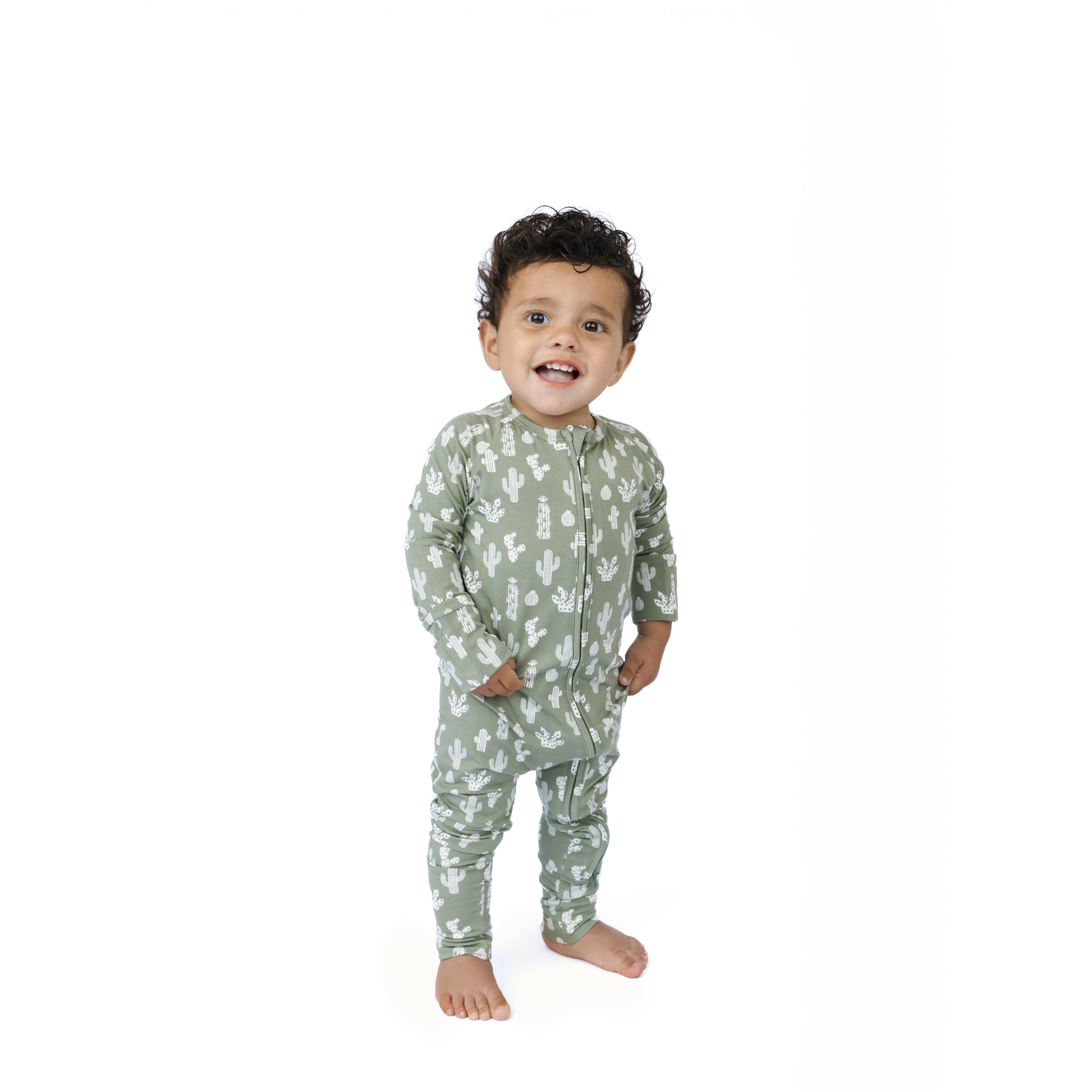 Child wearing a green cactus pajama set with a pattern on a white background
