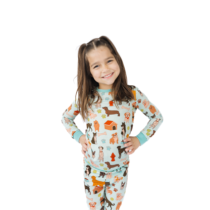 Child wearing pajamas with dog pattern on a white background