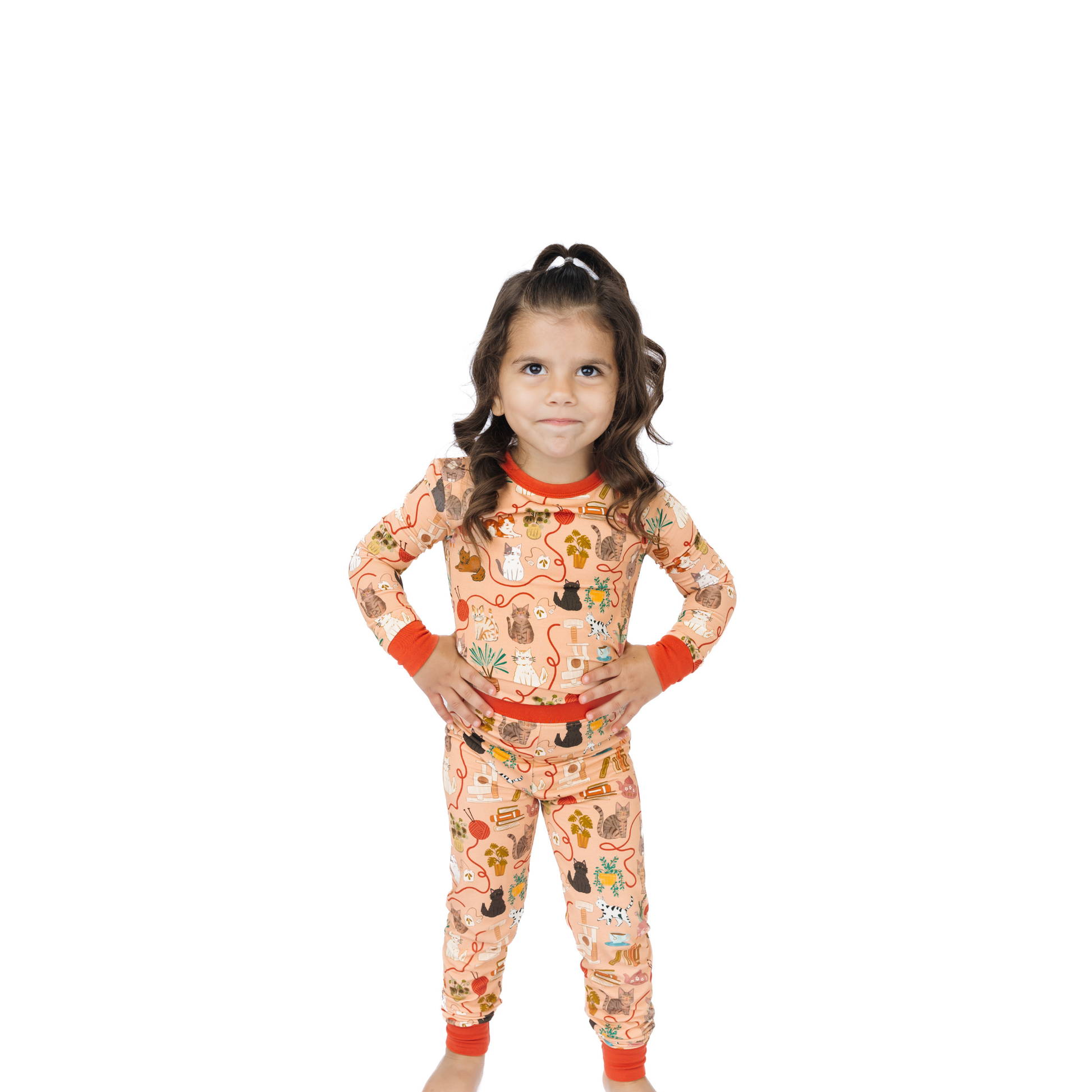 girl wearing cat printed pajamas on white background