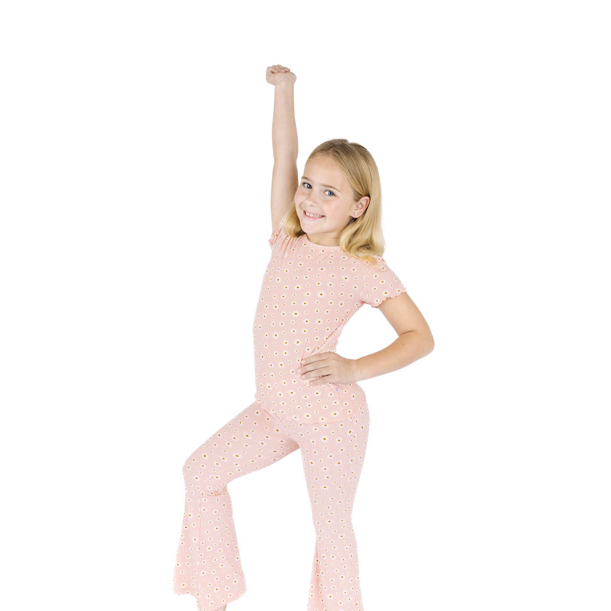 Young girl wearing a pink polka dot outfit on a white background