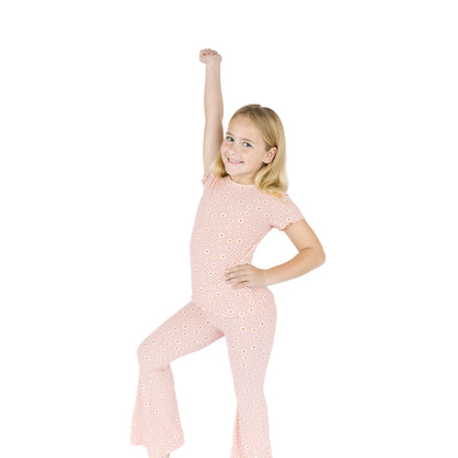 Young girl wearing a pink polka dot outfit on a white background