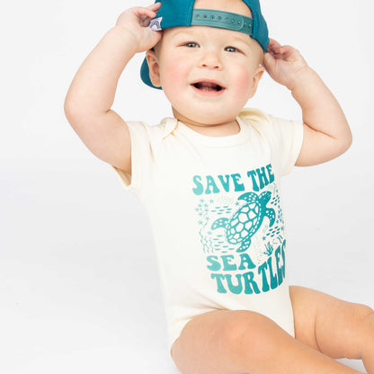 Baby wearing our Save the Sea Turtle  bodysuit made of 100% cotton by Emerson and Friends. He also have our Save the Sea Turtle hat. 
