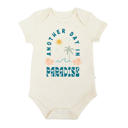 Baby bodysuit with 'Another Day in Paradise' text and graphics on a white background