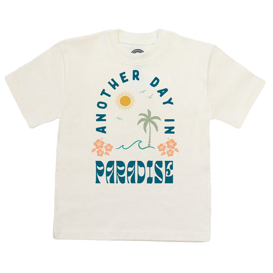 White t-shirt with 'Another Day in Paradise' design featuring palm trees and flowers on a white background