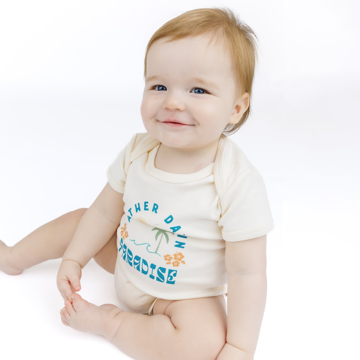 Baby wearing a white bodysuit with text and graphics on a white background