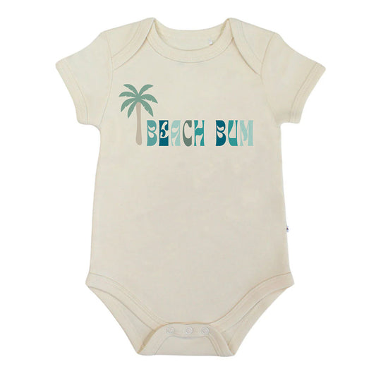 Beige baby bodysuit with 'Beach Bum' and palm tree design on a white background