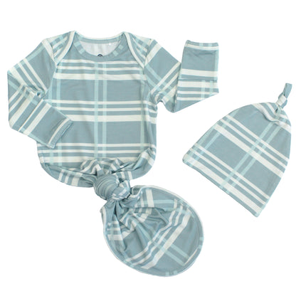 Baby outfit set with striped shirt, hat, and headband on a white background