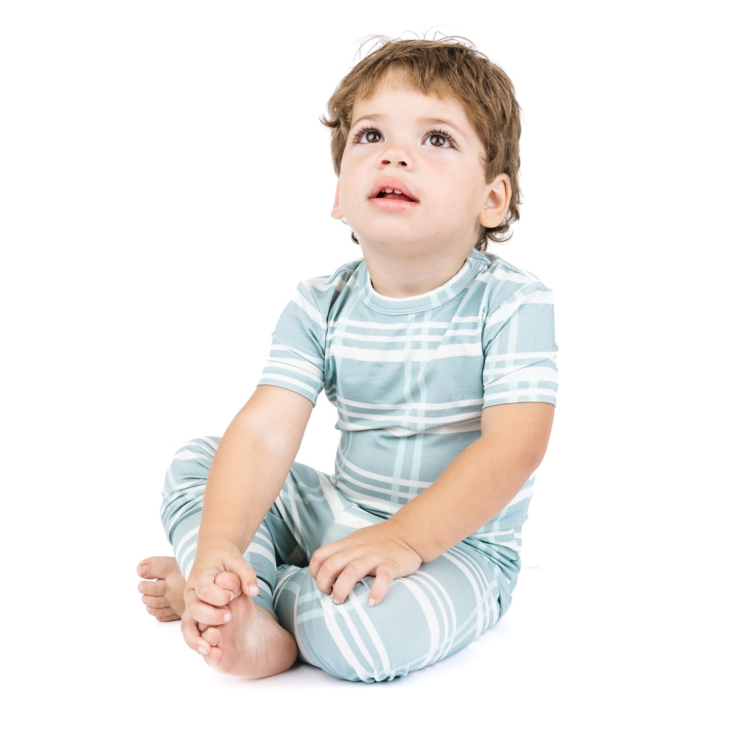 Child wearing a blue and white striped outfit on a white background