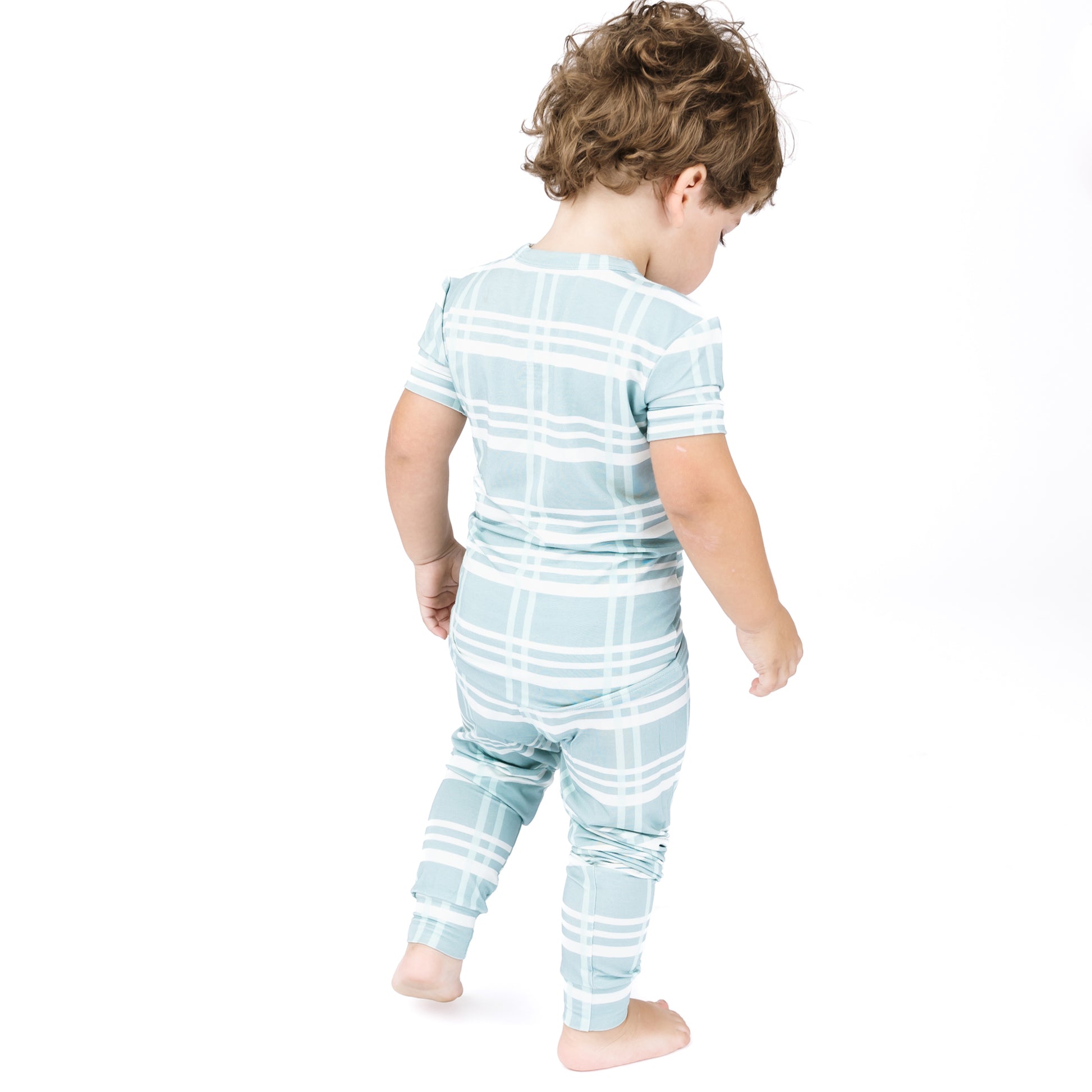 Child wearing a blue and white striped outfit on a white background