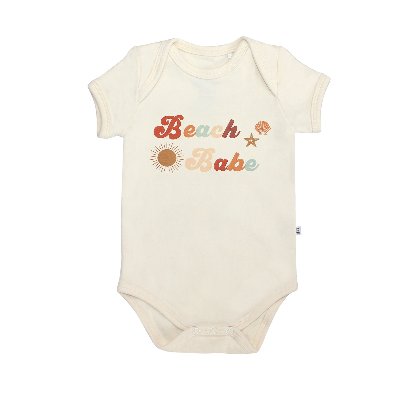 the "beach babe" cotton bodysuit. the word 'beach babe' is spelt out in a groovy font with a sun, starfish, and shell surrounding it. 