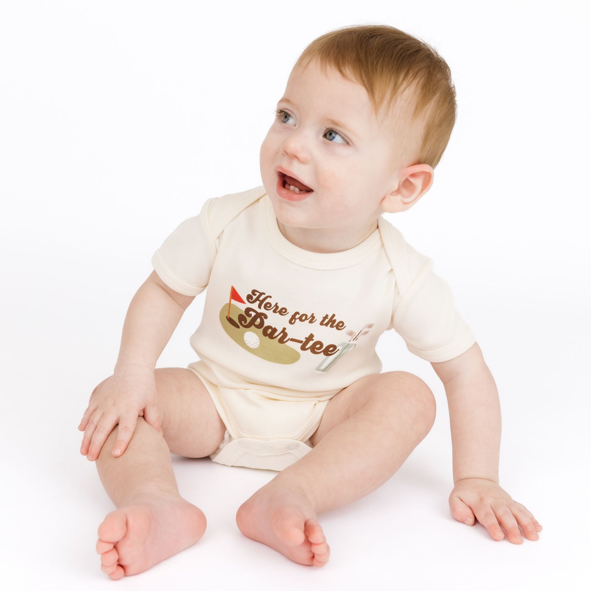 Baby wearing a bodysuit with text and graphics on a white background