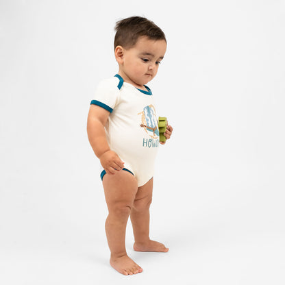 Baby boy wearing our Howdy cotton bodysuit featuring the word "Howdy" in playful, blue letters, perfect for a western outfit.