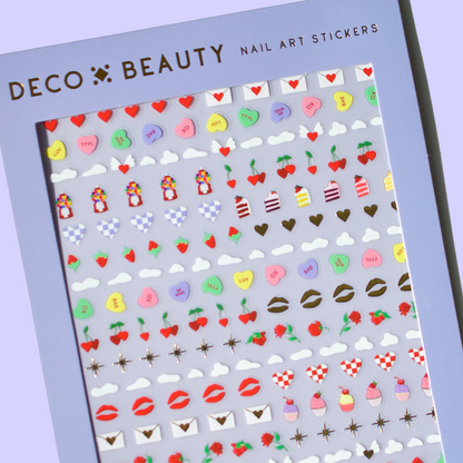 Sheet of nail art stickers with various designs on a purple background