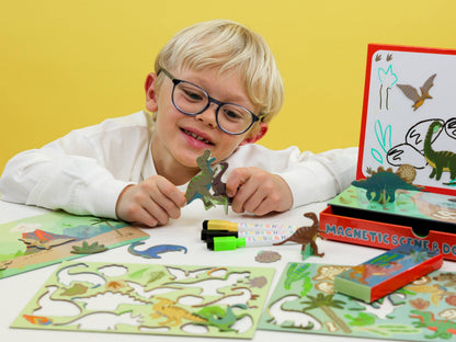 Child playing with a magnetic scene and dot toy set on a yellow background