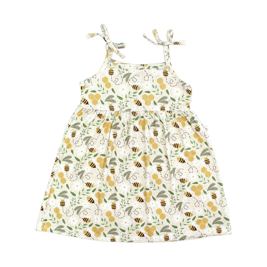 Adorable bamboo sundress featuring a happy honey bee and honeycomb print. Made from lightweight, breathable, and hypoallergenic fabric, perfect for warm-weather comfort.