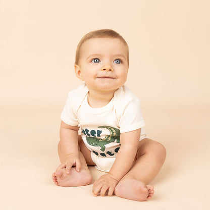 a smiling baby in the "later gator" cotton bodysuit