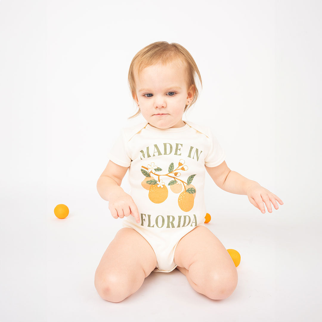 Baby wearing the "made in Florida" cotton bodysuit