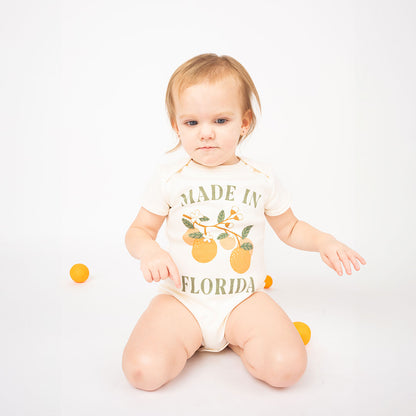 Baby wearing the "made in Florida" cotton bodysuit