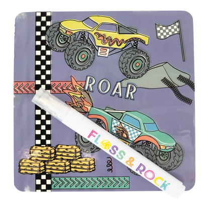 Children's book with monster truck illustrations and a pen on a white background