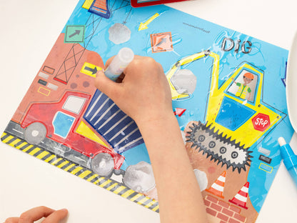 Child's hand coloring a construction-themed coloring book with crayons.