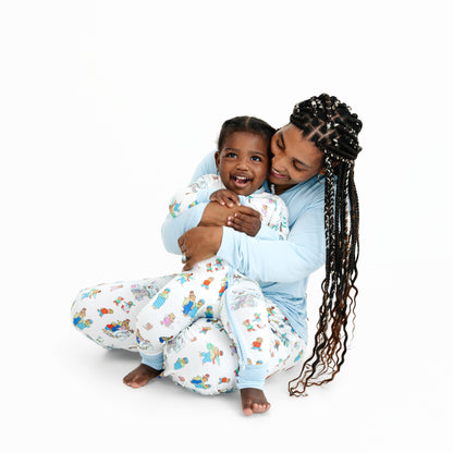 Woman and child in matching Berenstain Bears Snow Day pajamas on a white background