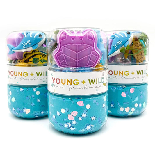 Three small containers with animal designs and 'Young + Wild' branding on a white background