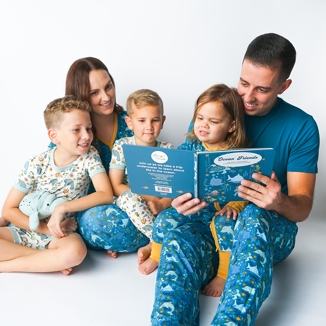 family reads the "ocean friends" board book. 