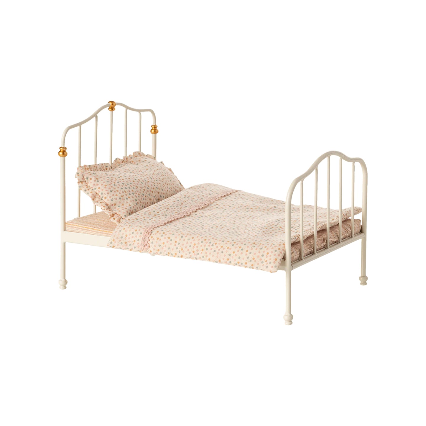 Small bed with beige bedding and pillows on a white background
