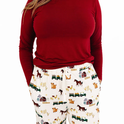 Close up of woman wearing On the Farm bamboo relaxed lounge pajama pants with barnyard animal and tractor print, hypoallergenic fabric.