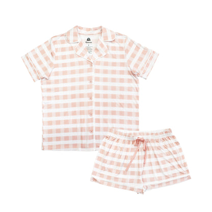 Pink and white checkered shirt and shorts set on a white background