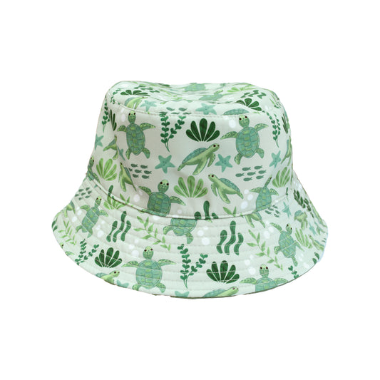 Save the Sea Turtles and Lucky Green Reversible Bucket Hat by Emerson and Friends, featuring an ocean-inspired turtle print on one side and a solid lucky green color on the other. Made from lightweight, quick-dry fabric perfect for sunny adventures.