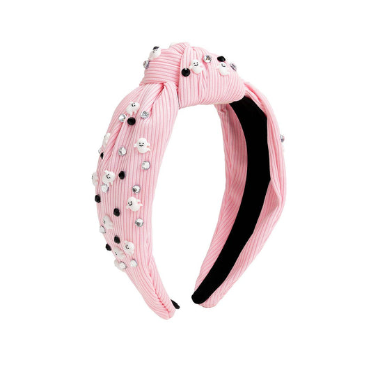 pink headband with black and clear crystals and little ghost charms on it