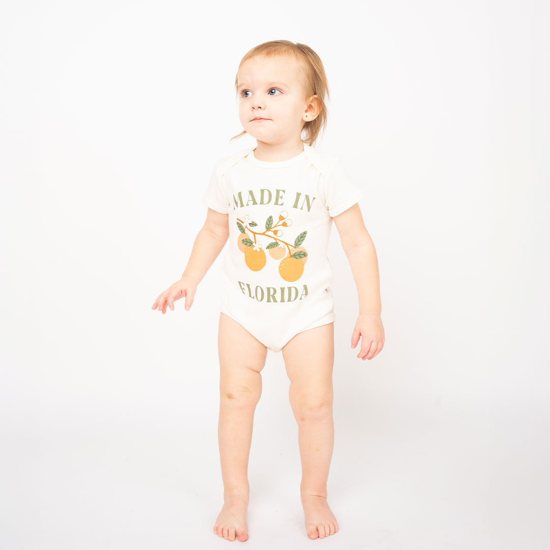 Baby wearing the "made in Florida" bodysuit