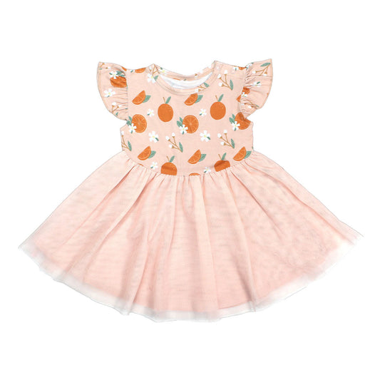 the "freshly squeezed" twirl dress. this dress has the "freshly squeezed" print on the top half and a pink skirt as the bottom half. the "freshly squeezed" print has an assortment of full and half cut oranges scattered around. there is also flower heads and flower stems that intermingle within the print. this is all space out around a pink background space. 