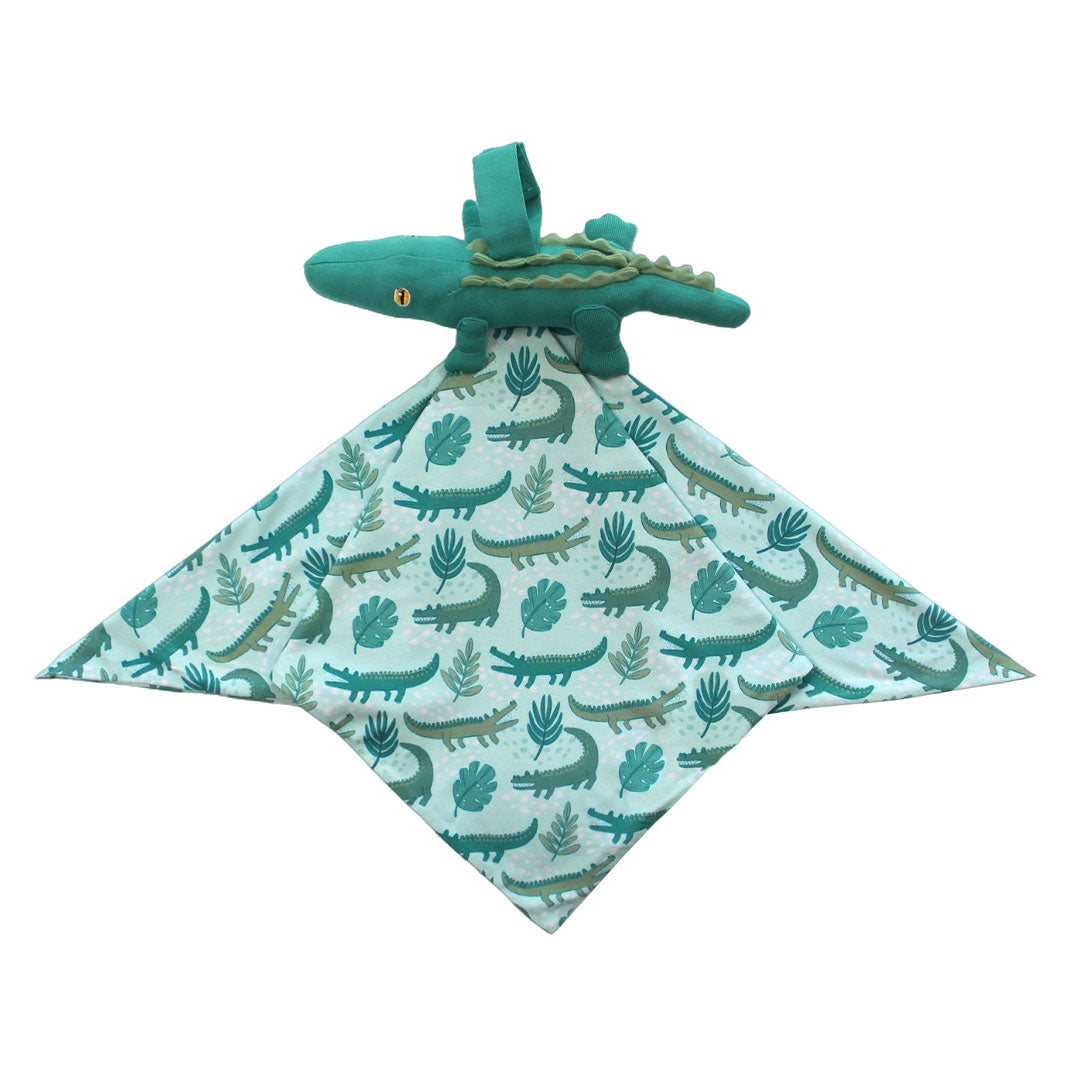 This is the "later gator" lovey. the "later gator" print has a mix of light and dark green alligators, leaves, and white dots scattered on a teal colored background. 