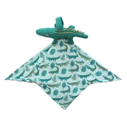 This is the "later gator" lovey. the "later gator" print has a mix of light and dark green alligators, leaves, and white dots scattered on a teal colored background. 