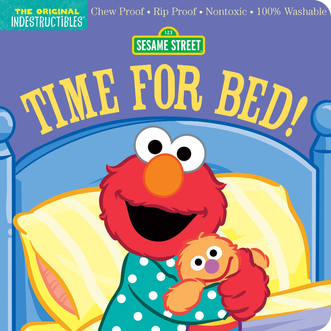 Elmo tucked into bed with his stuffed toy