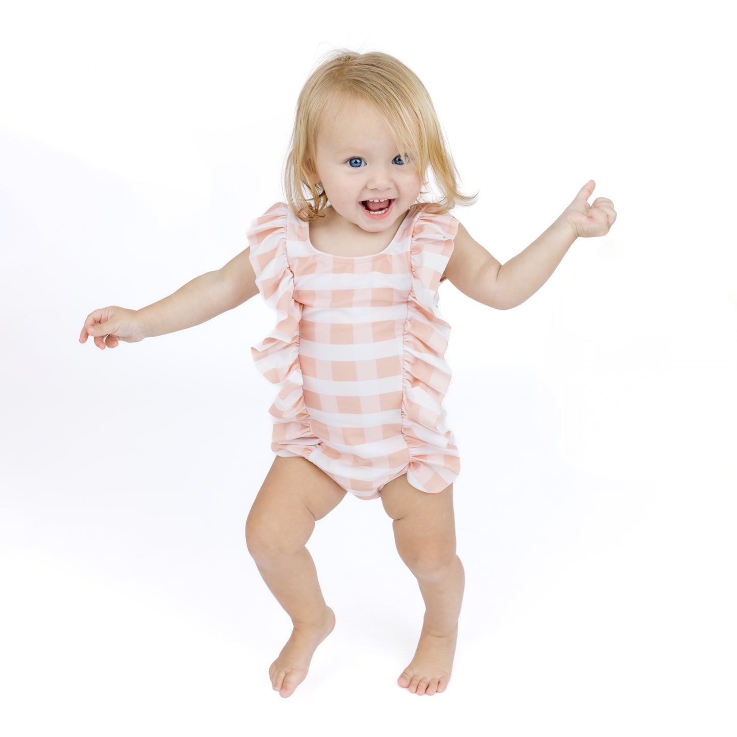 Child wearing a pink and white striped romper on a white background