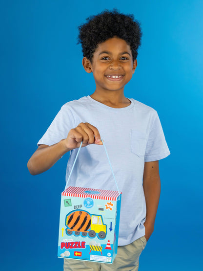 Child holding a puzzle box with a blue background
