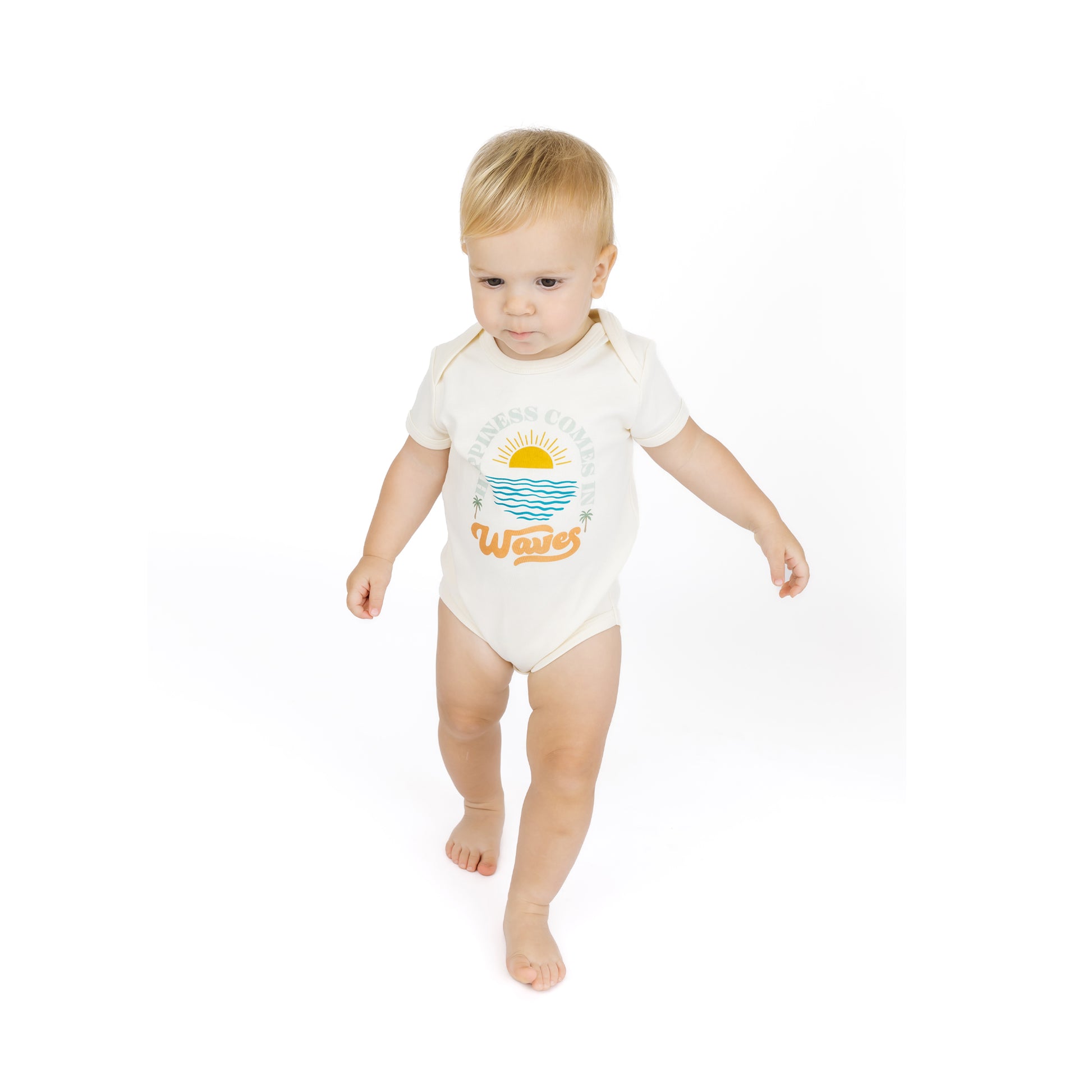 Baby wearing a white bodysuit with a graphic design on a white background