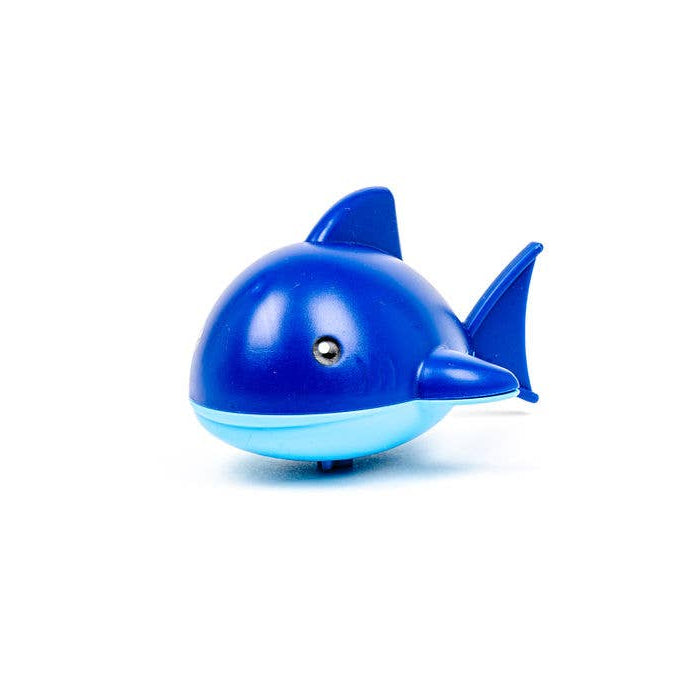 Blue smiling wind up shark bath toy crawling on flat surface