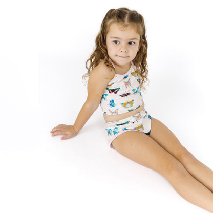 Young girl wearing a colorful outfit with a white background
