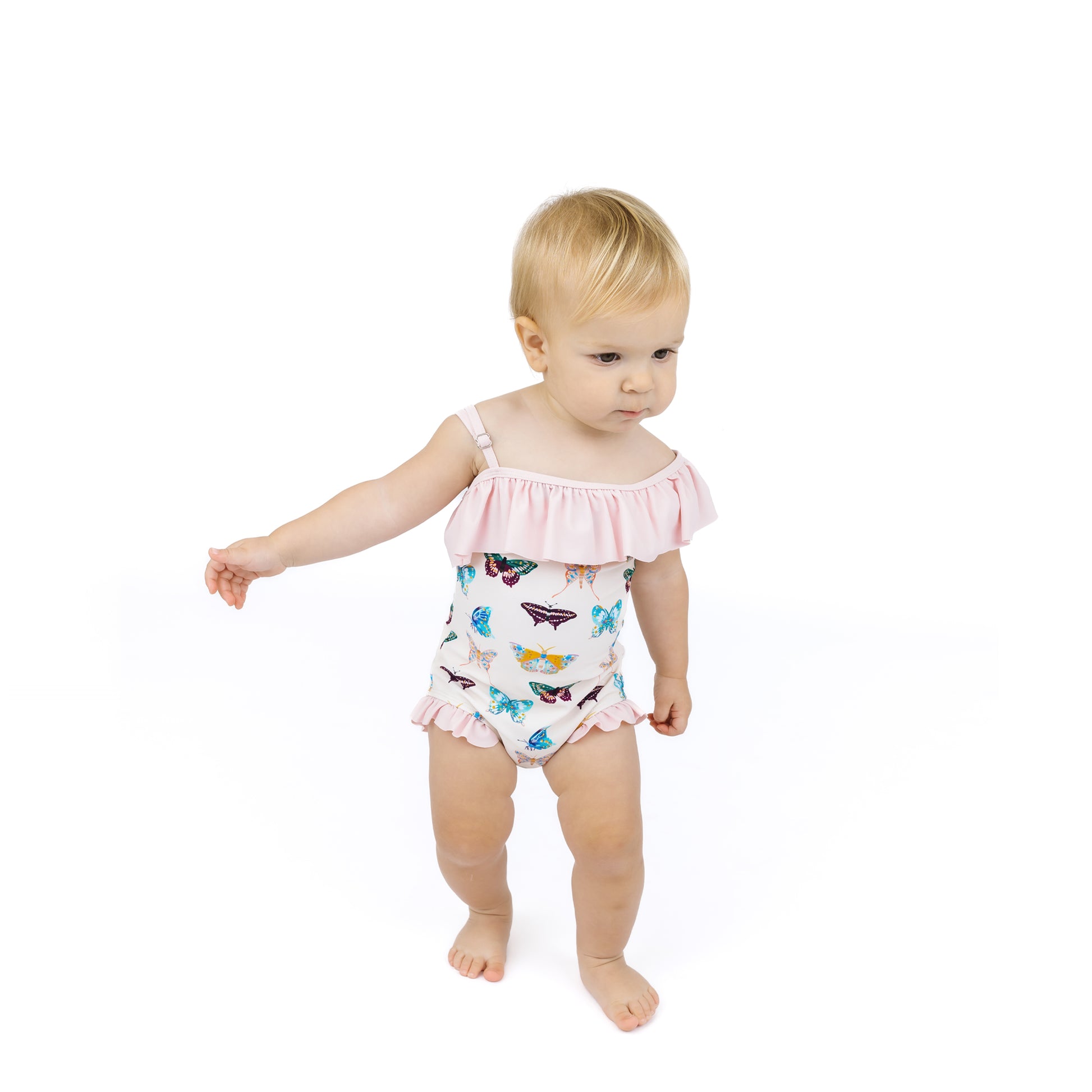 Baby wearing a butterfly-patterned swimsuit on a white background