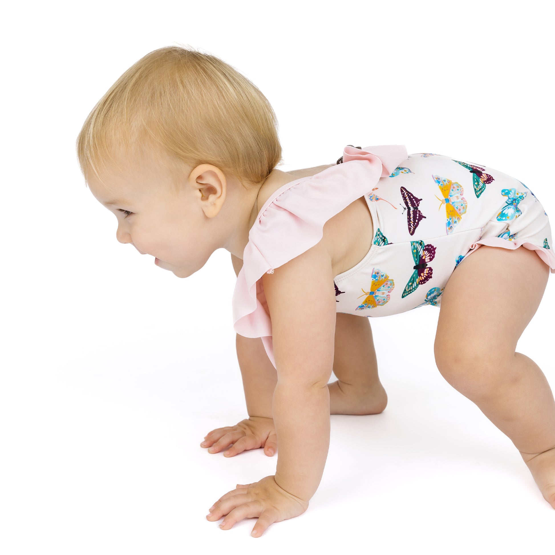 Baby in a diaper with a colorful butterfly pattern on a white background
